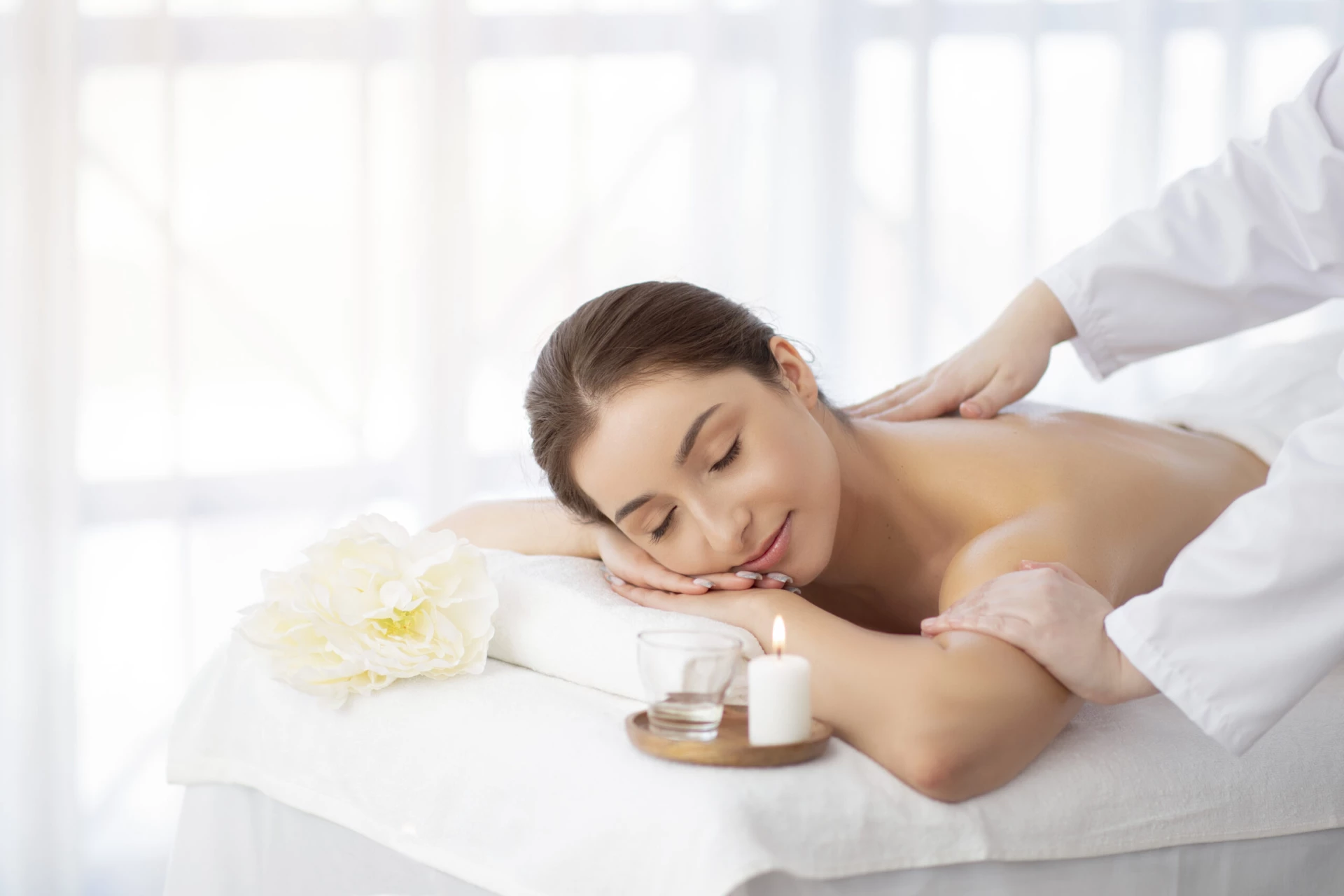 Spa Massage. Indian Woman Relaxing On Table While Therapist Massaging Her Shoulders Massage